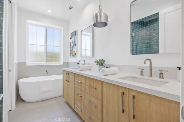 a bathroom with a double vanity sink tub and a mirror