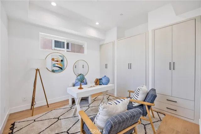 a living room with furniture a rug and a window