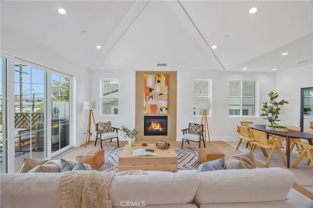 a living room with furniture and large windows