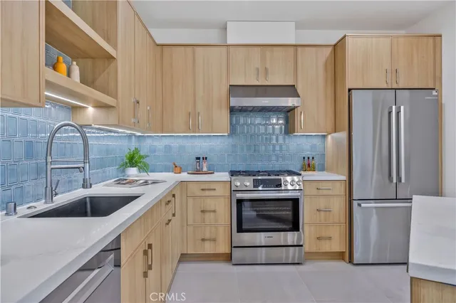 a kitchen with a sink stove and refrigerator