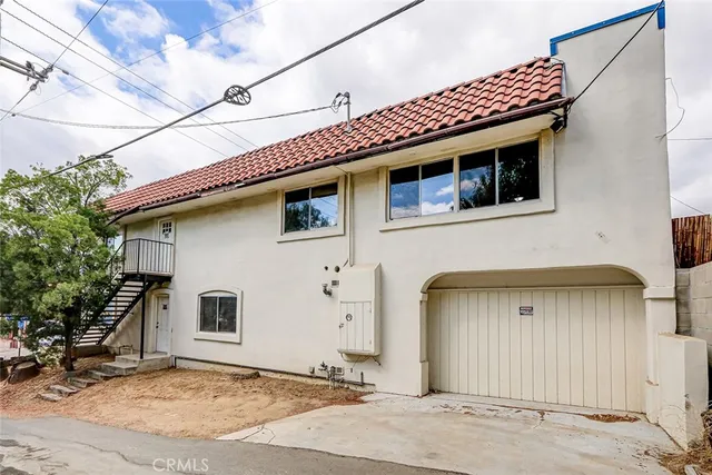 an aerial view of a residential houses with outdoor space