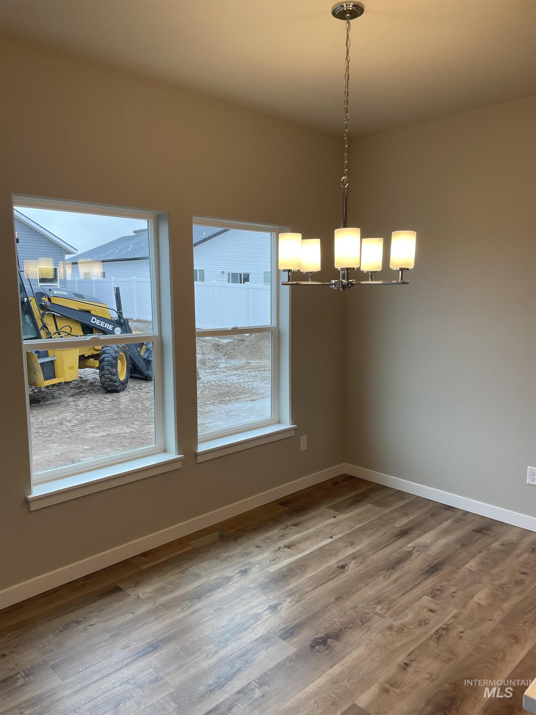 1123 Frank Henry Road Twin Falls, ID 83301 - Photo 5 of 20 Unfurnished dining area with light wood-style flooring and a chandelier