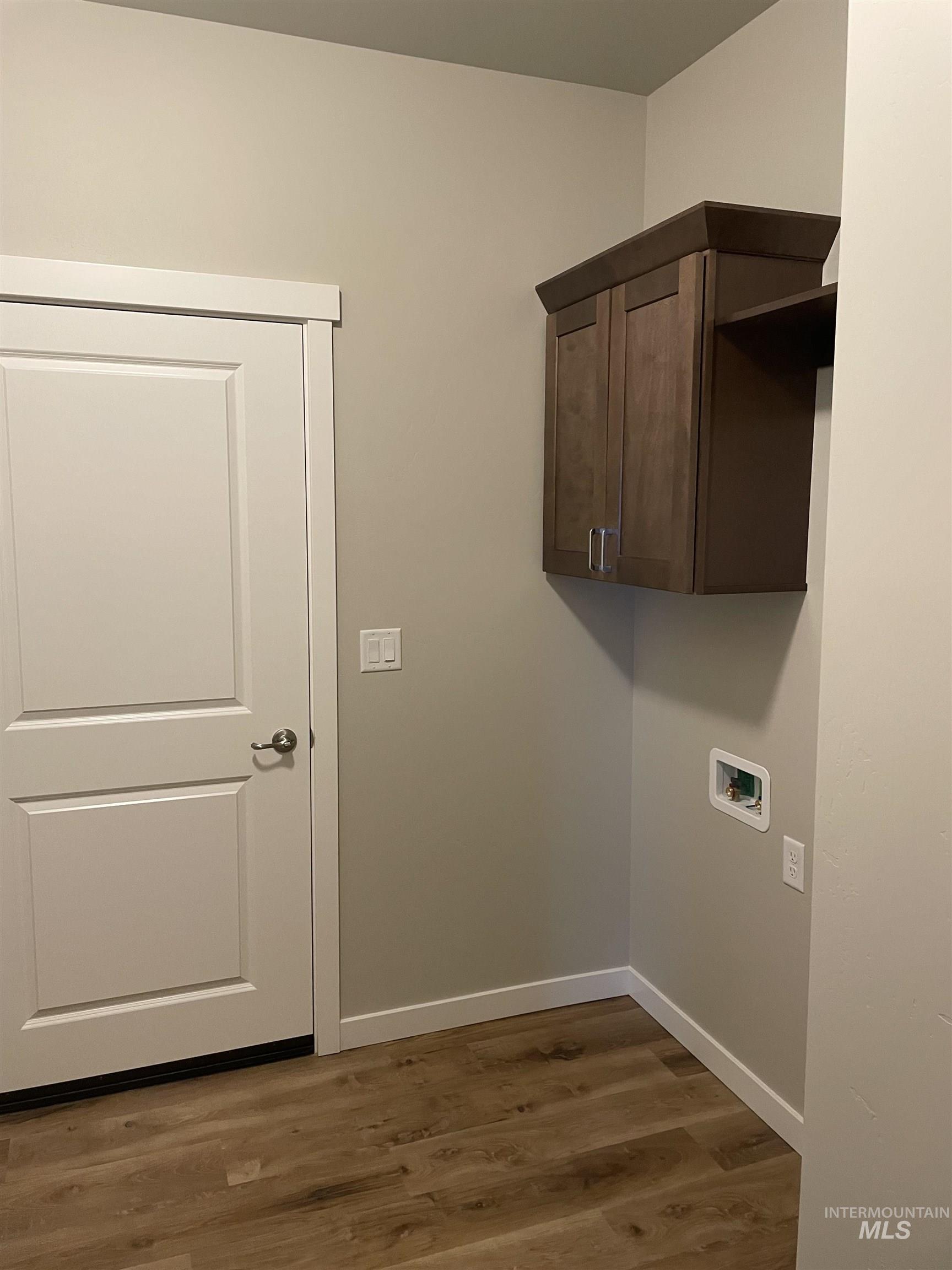 1123 Frank Henry Road Twin Falls, ID 83301 - Photo 7 of 20 Laundry room with dark wood finished floors and cabinet space