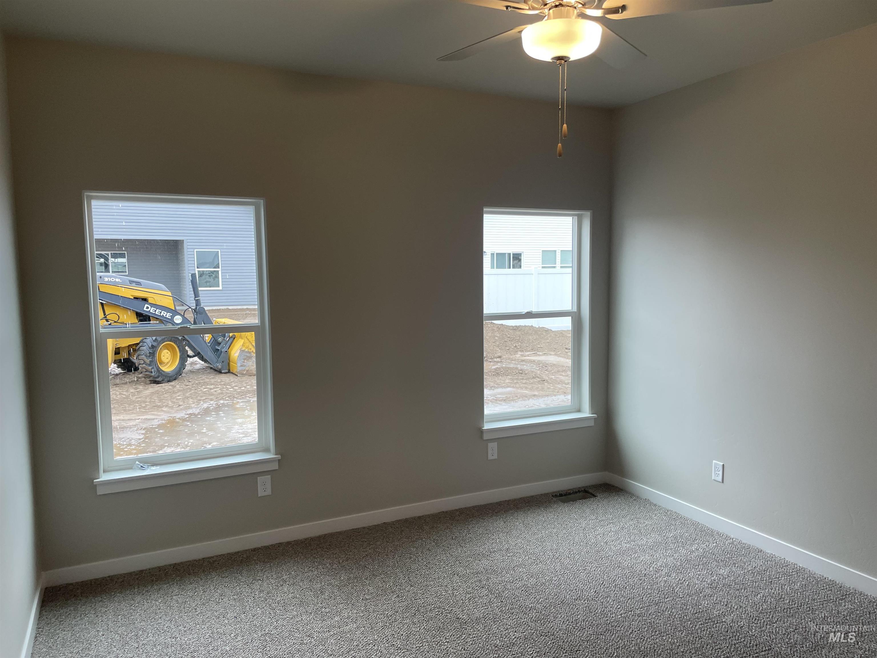 1123 Frank Henry Road Twin Falls, ID 83301 - Photo 9 of 20 Empty room with carpet floors and a ceiling fan