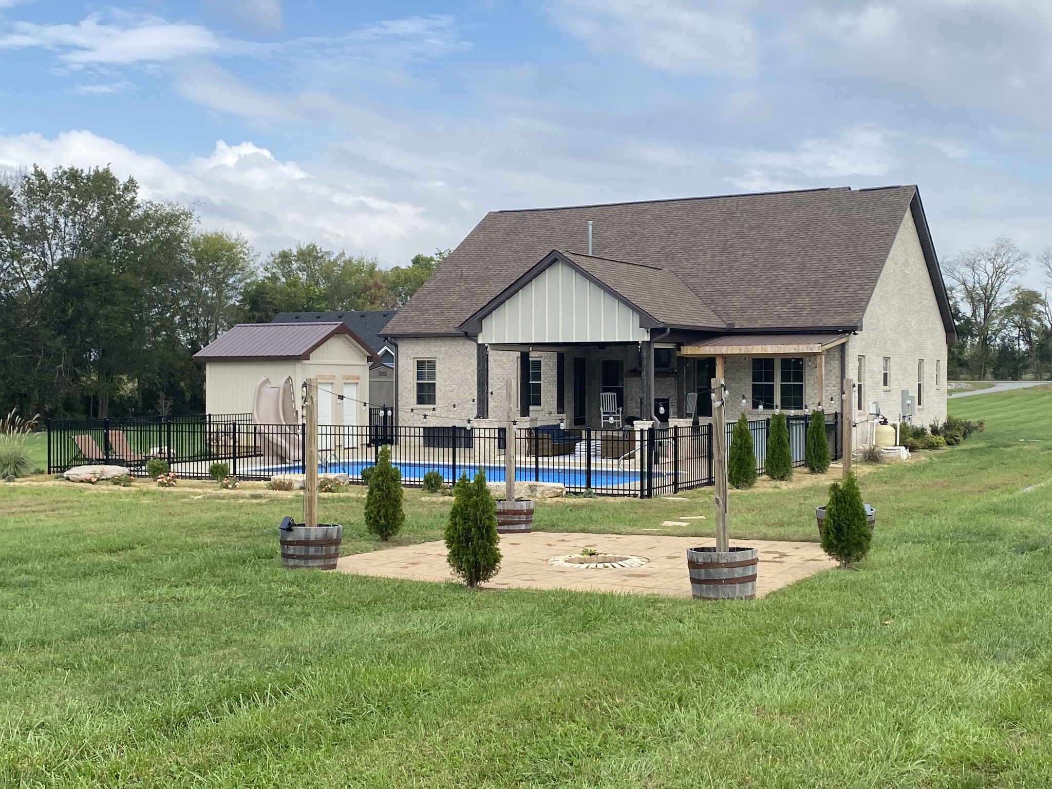 535 Tom Link Road Cottontown, TN 37048 - Photo 2 of 37 a front view of a house with swimming pool and a garden