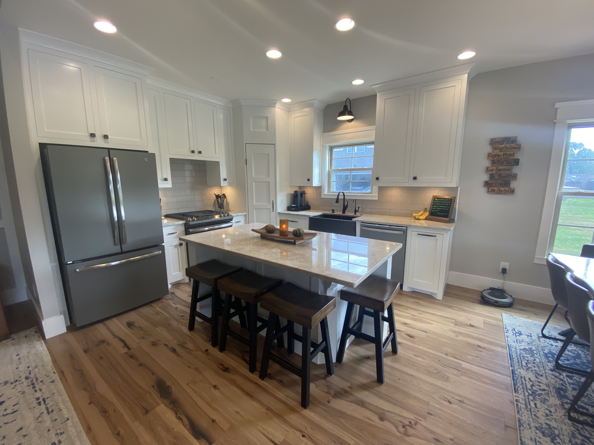 535 Tom Link Road Cottontown, TN 37048 - Photo 11 of 37 a kitchen with stainless steel appliances granite countertop a dining table chairs stove refrigerator and cabinets