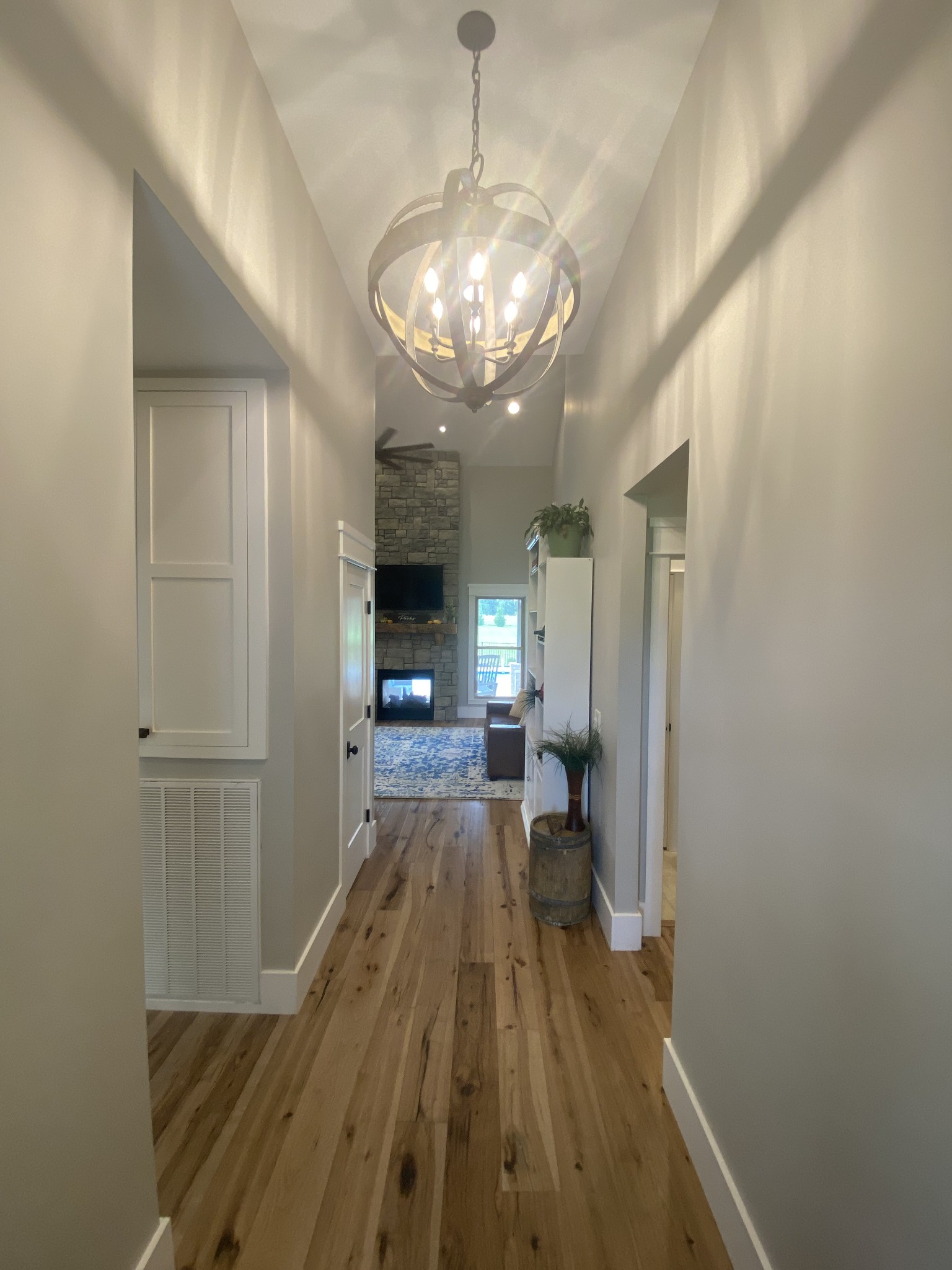 535 Tom Link Road Cottontown, TN 37048 - Photo 5 of 37 a view of a livingroom with a fireplace a chandelier and wooden floor