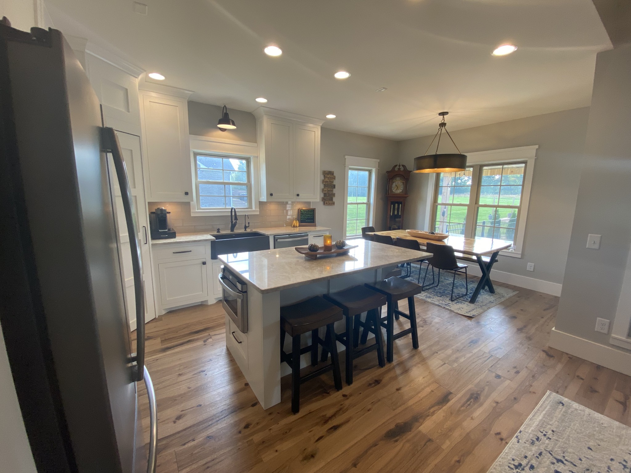 535 Tom Link Road Cottontown, TN 37048 - Photo 10 of 37 a kitchen with stainless steel appliances granite countertop a refrigerator a sink a stove a dining table and chairs