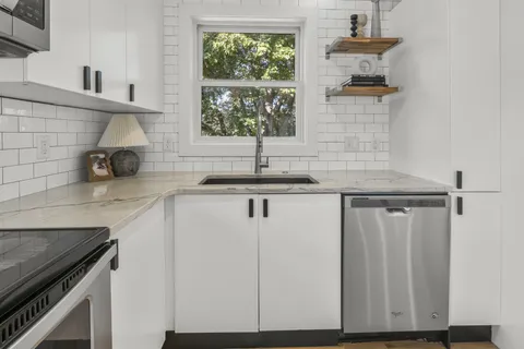 a kitchen with a sink cabinets and window