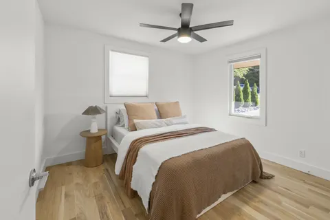 a bedroom with a bed and a window