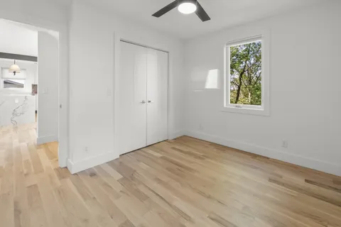 an empty room with windows and closet
