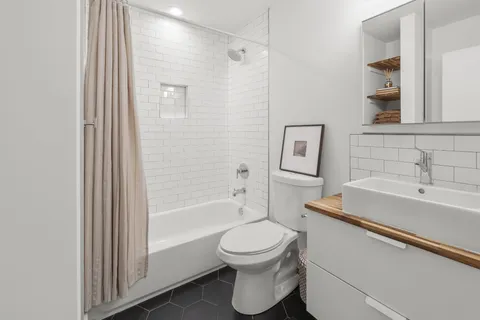 a bathroom with a sink toilet and shower