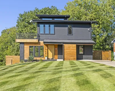 a front view of a house with a garden