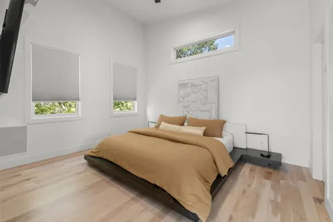 a bedroom with a bed and a window