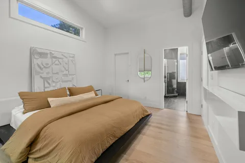 a bedroom with a bed and a couch