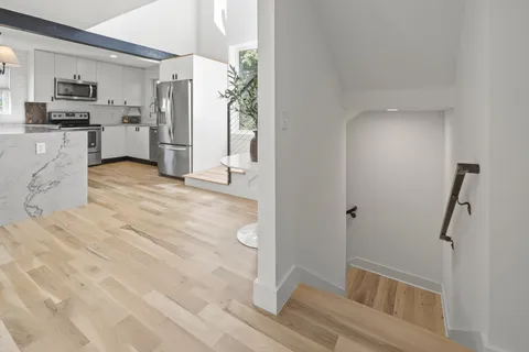 a bathroom with a tub shower and a sink