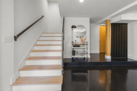 a view of entryway and hall with wooden floor
