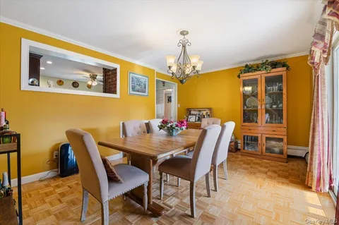 a view of a dining room with furniture and a chandelier