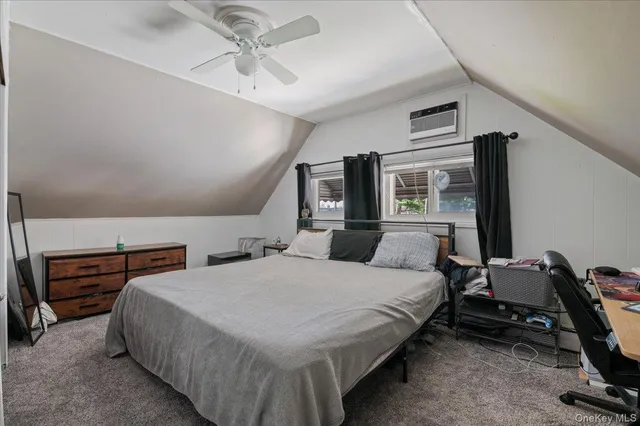 a bedroom with bed and wooden floor