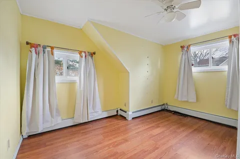 an empty room with wooden floor and door