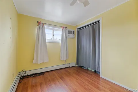 an empty room with wooden floor and closet
