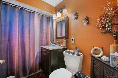 a bathroom with a toilet a sink and mirror