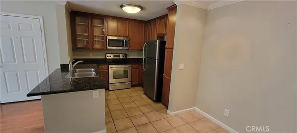 a kitchen with stainless steel appliances a refrigerator and a stove top oven