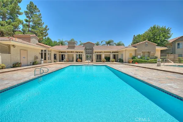 a view of a house with swimming pool and porch