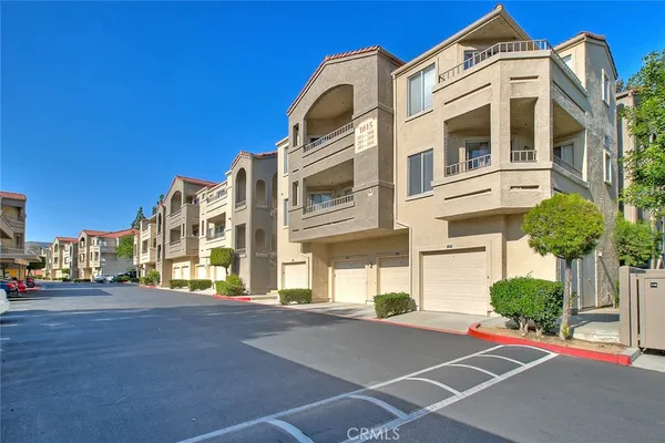 a view of a tall building next to a road