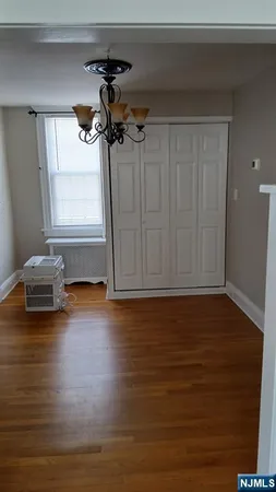 a view of a room with wooden floor and a window
