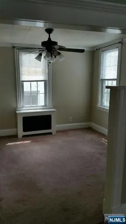 a view of room with a ceiling fan and window