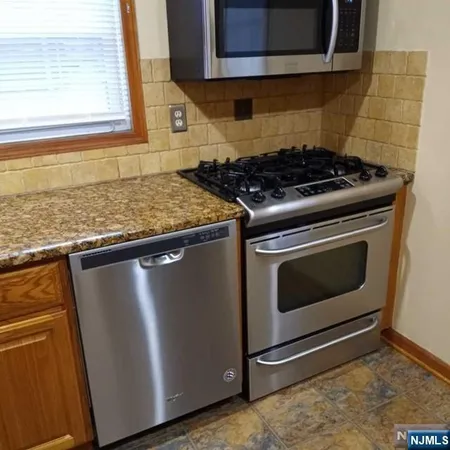 a stove top oven sitting inside of a kitchen