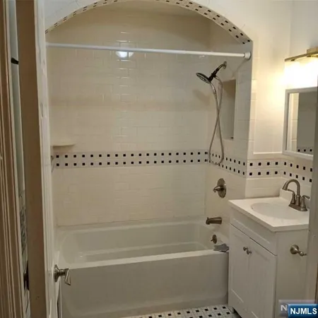 a bathroom with a shower and a sink