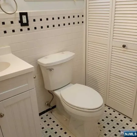 a white toilet sitting next to a shower curtain