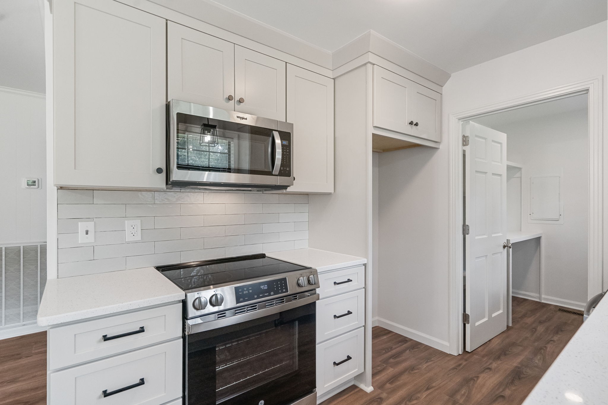 407 South Ray Road Portland, TN 37148 - Photo 10 of 47 a kitchen with stainless steel appliances white cabinets and a stove a oven with wooden floor