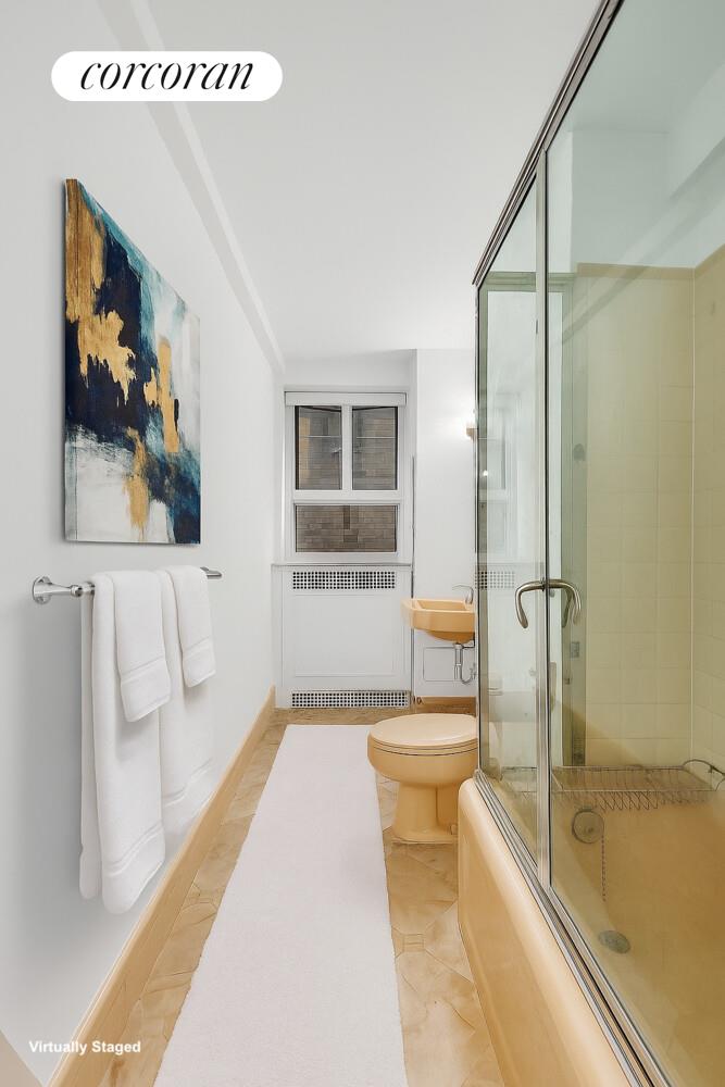 19 East 88th Street, Unit 4H Manhattan, NY 10128 - Photo 7 of 12 a bathroom with a tub a toilet and a shower