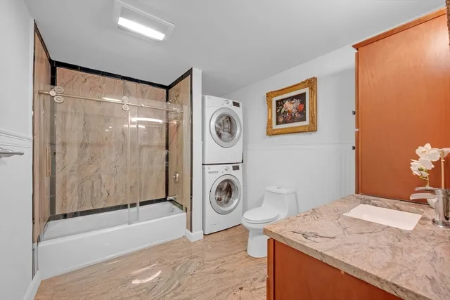a bathroom with a toilet a sink and mirror