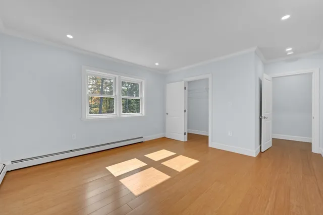 an empty room with a empty space and windows