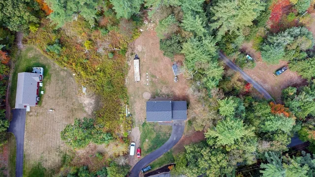 an aerial view of a house with a yard