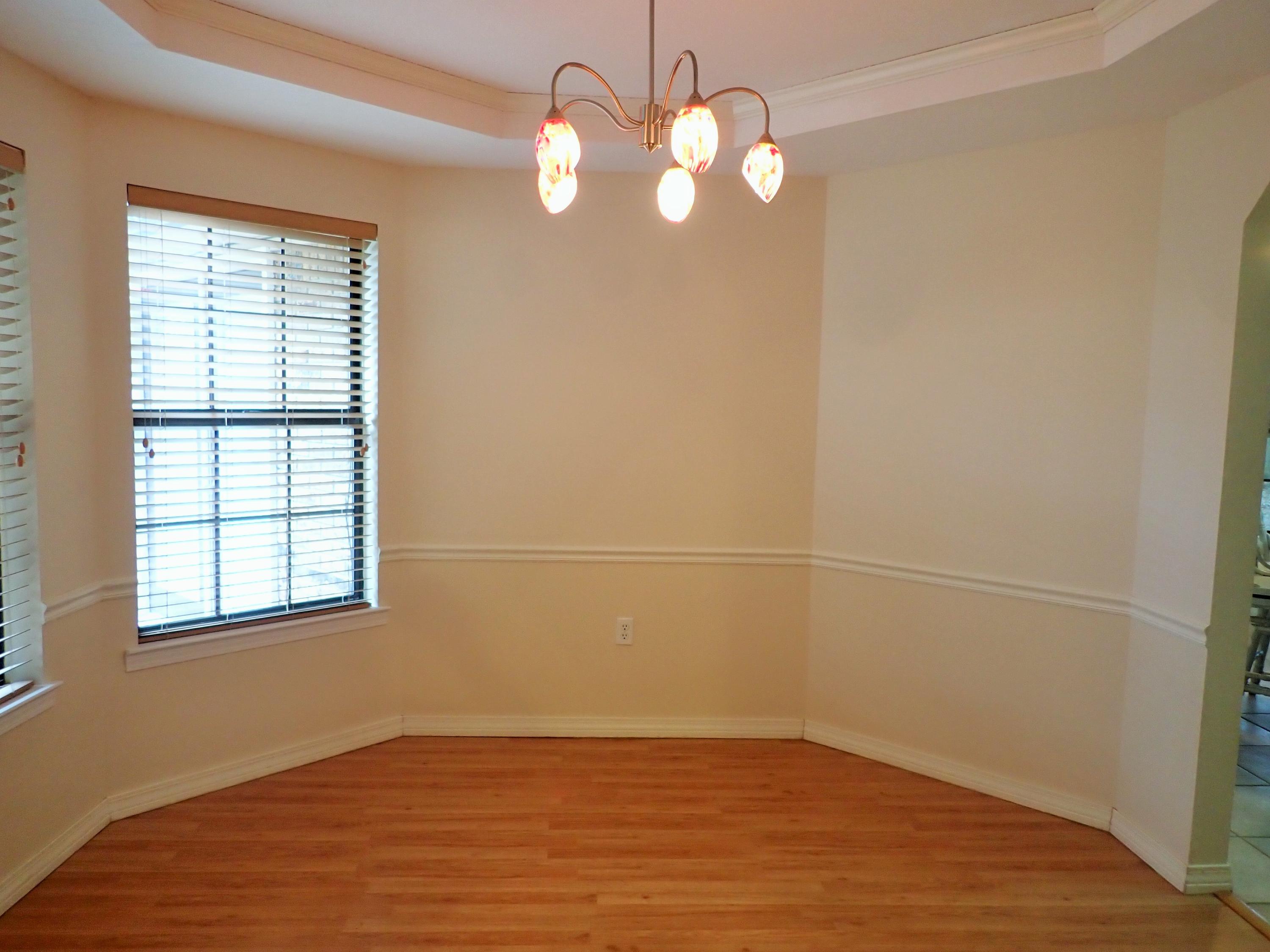 303 Sheldon Court Crestview, FL 32539 - Photo 11 of 45 an empty room with wooden floor and windows