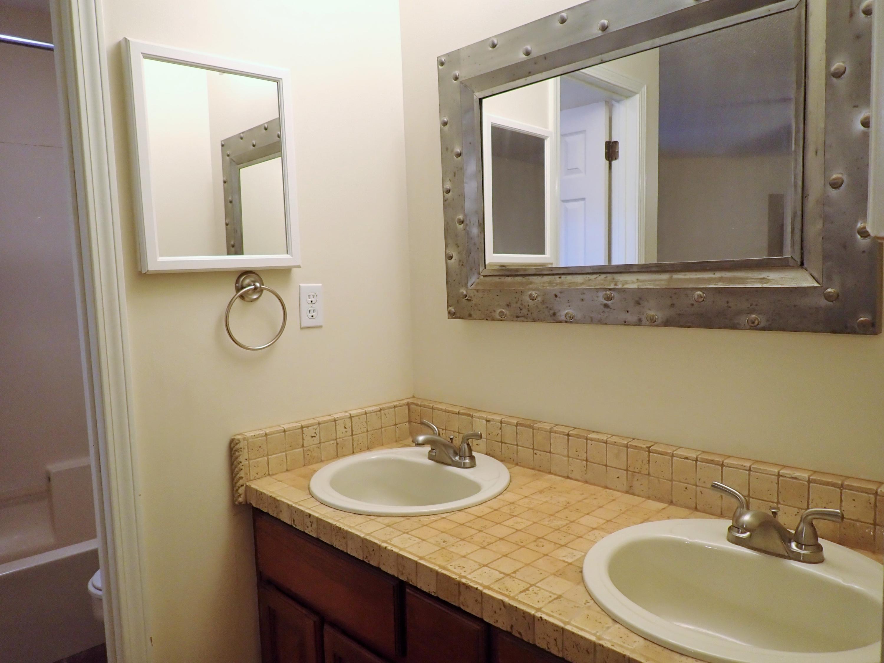 303 Sheldon Court Crestview, FL 32539 - Photo 15 of 45 a bathroom with a granite countertop sink and a mirror
