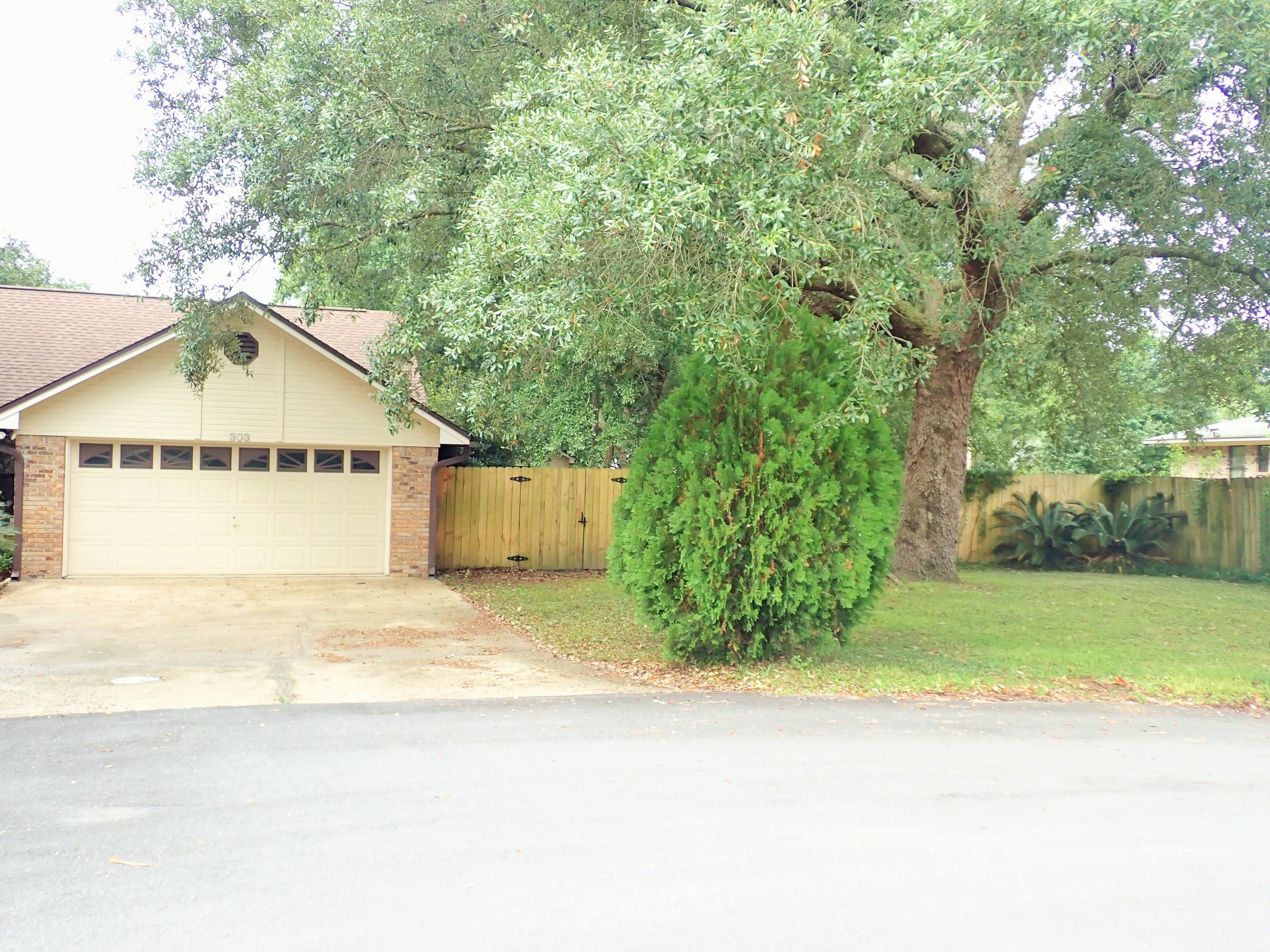 303 Sheldon Court Crestview, FL 32539 - Photo 3 of 45 a view of a house with a yard and garage