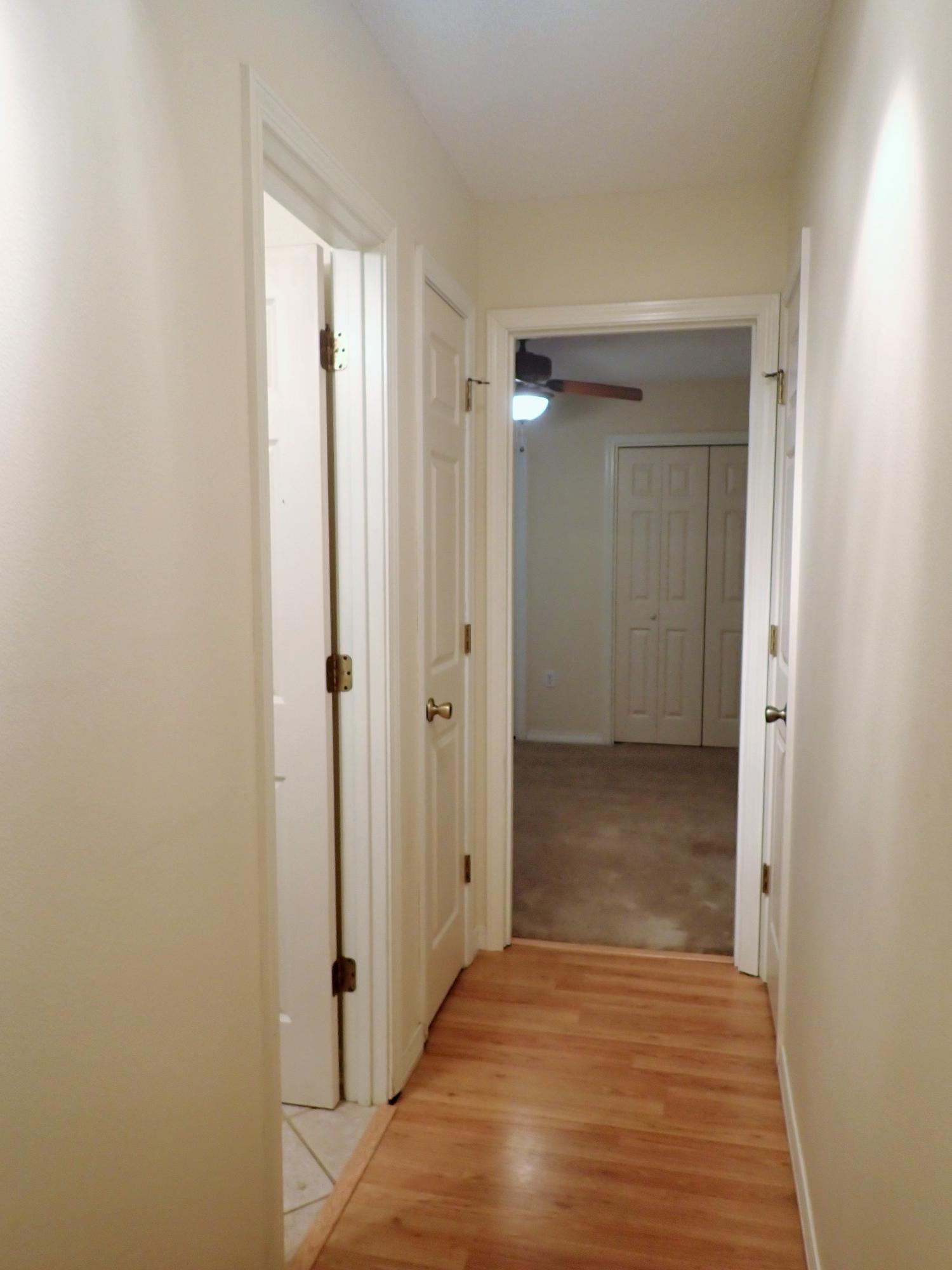 303 Sheldon Court Crestview, FL 32539 - Photo 23 of 45 a view of a hallway with wooden floor
