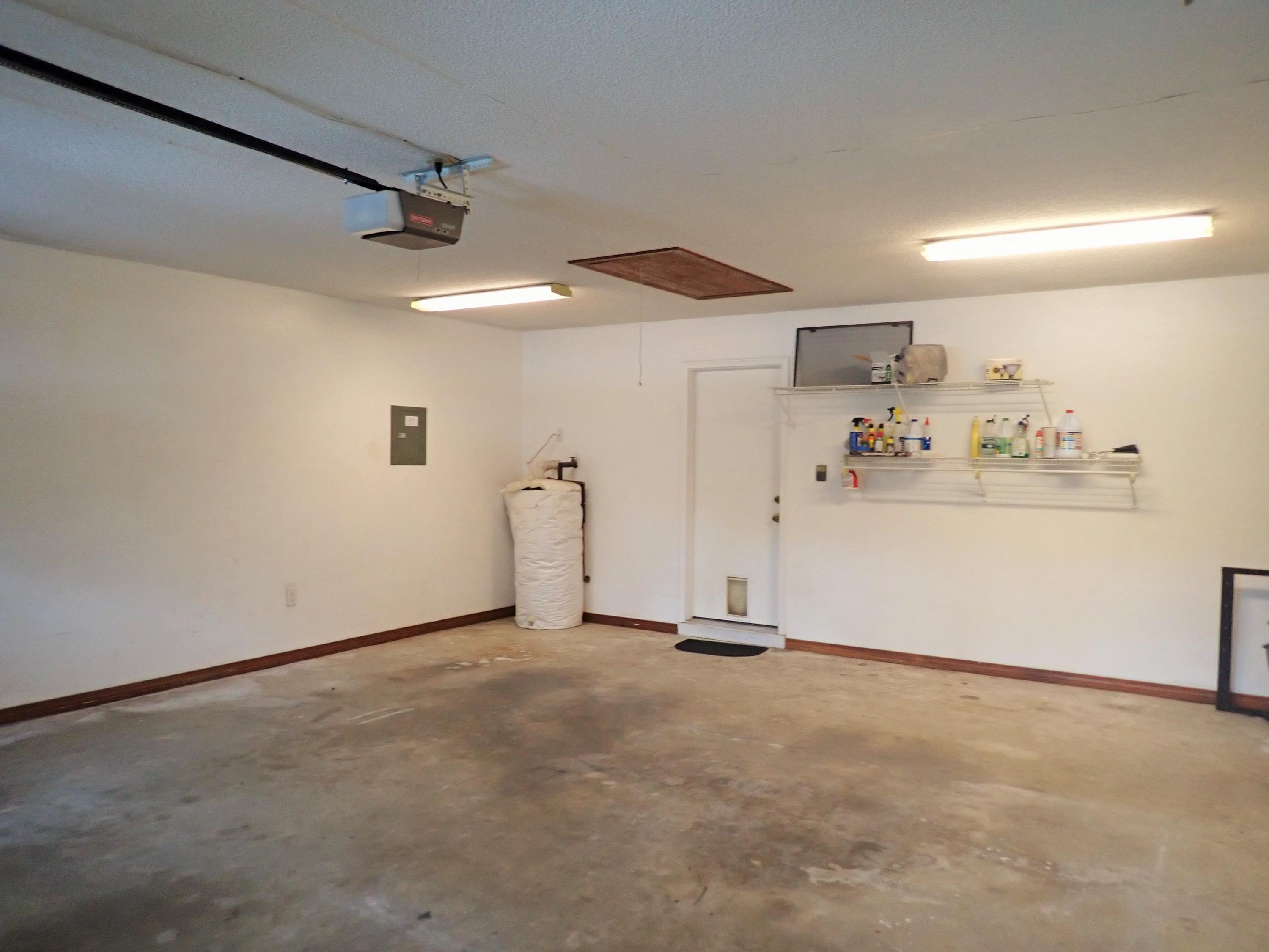 303 Sheldon Court Crestview, FL 32539 - Photo 29 of 45 an empty room with kitchen view and a ceiling fan
