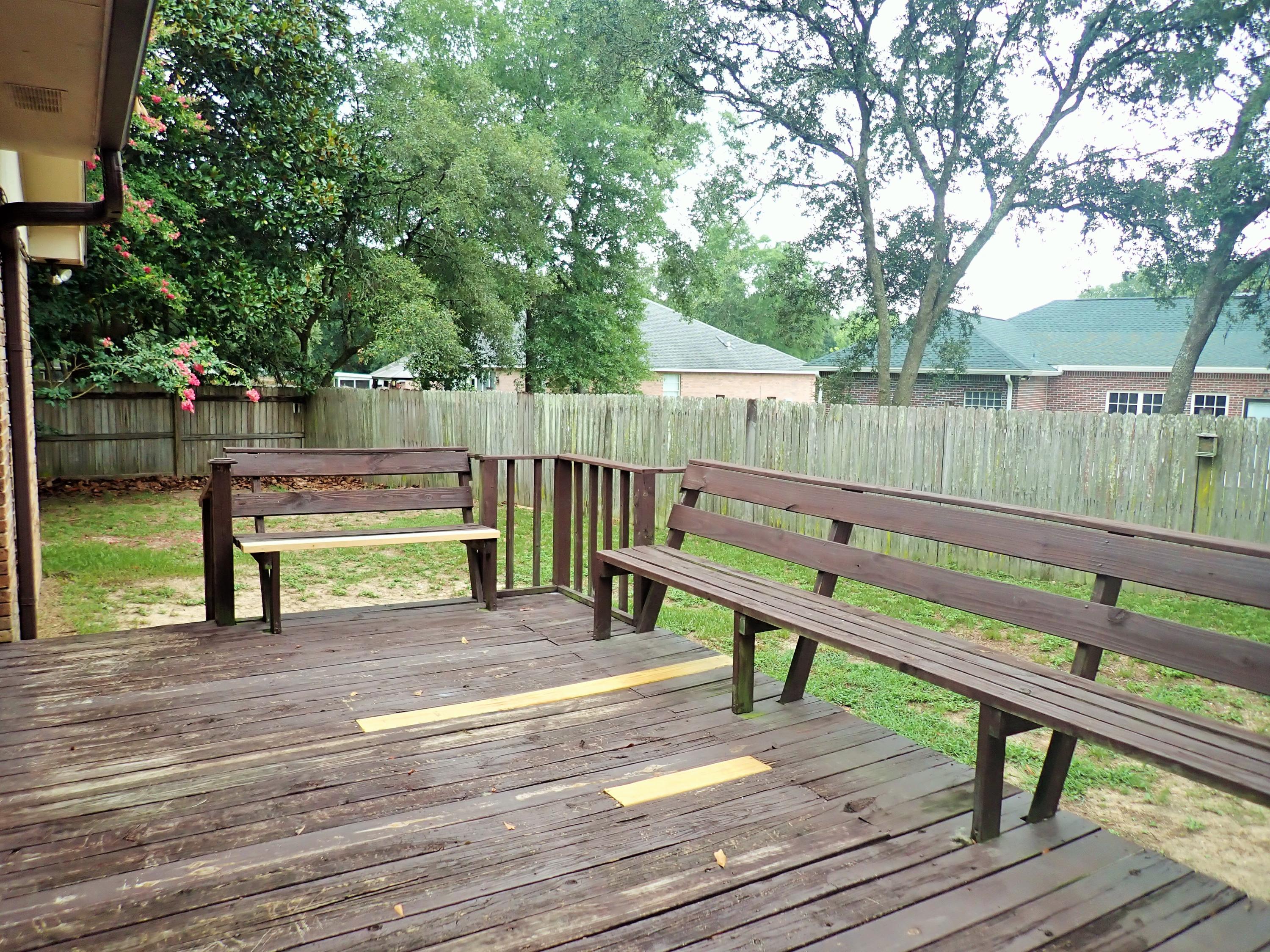 303 Sheldon Court Crestview, FL 32539 - Photo 34 of 45 a view of a park with wooden bench and trees