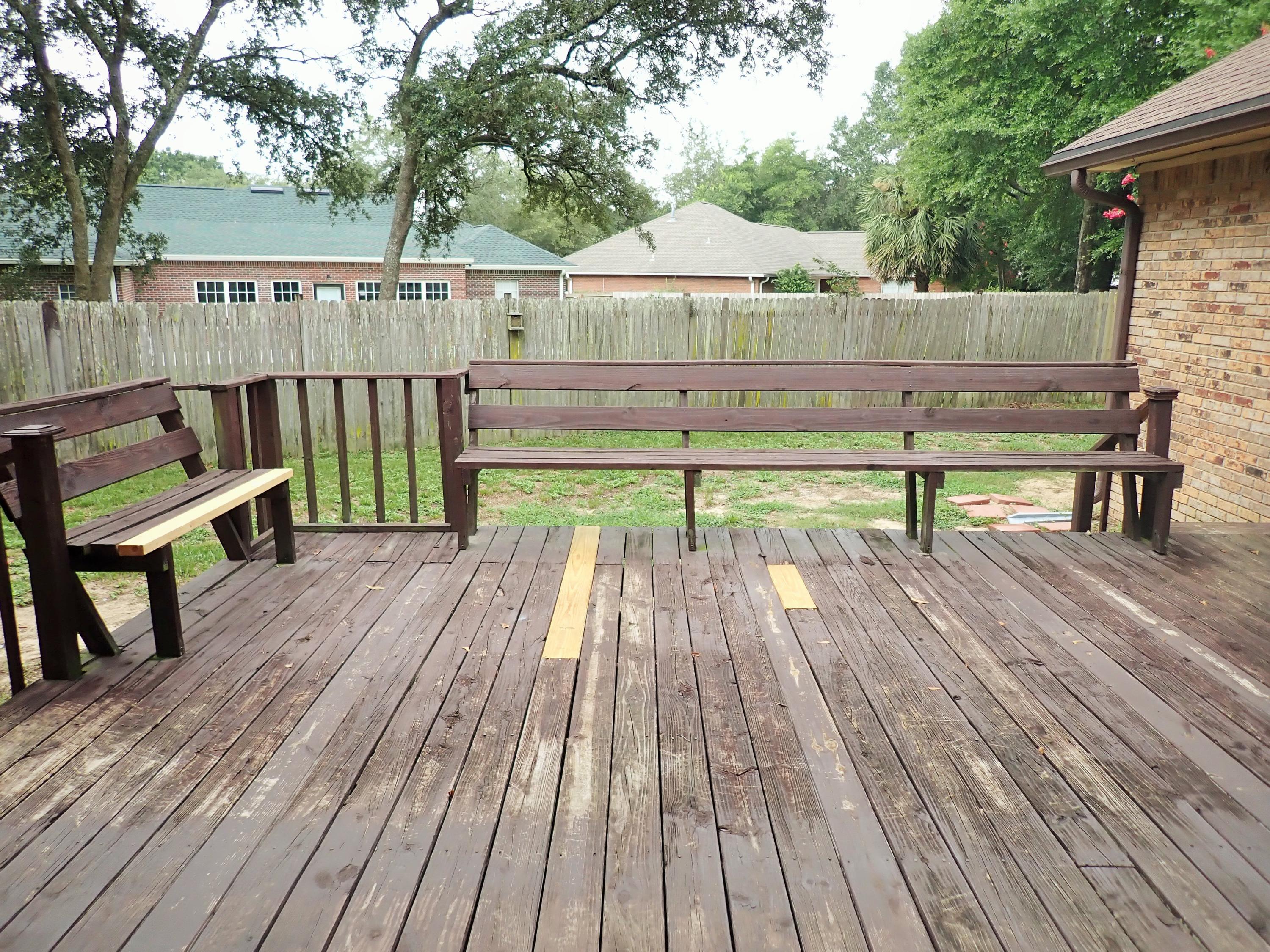 303 Sheldon Court Crestview, FL 32539 - Photo 35 of 45 a view of a deck with chair and wooden floor