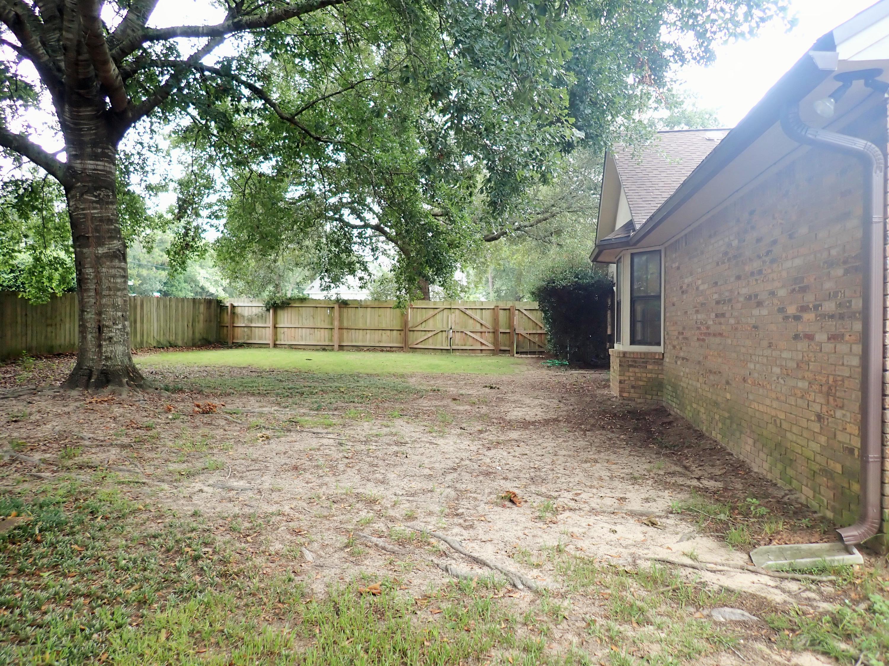 303 Sheldon Court Crestview, FL 32539 - Photo 39 of 45 a backyard of a house with lots of green space
