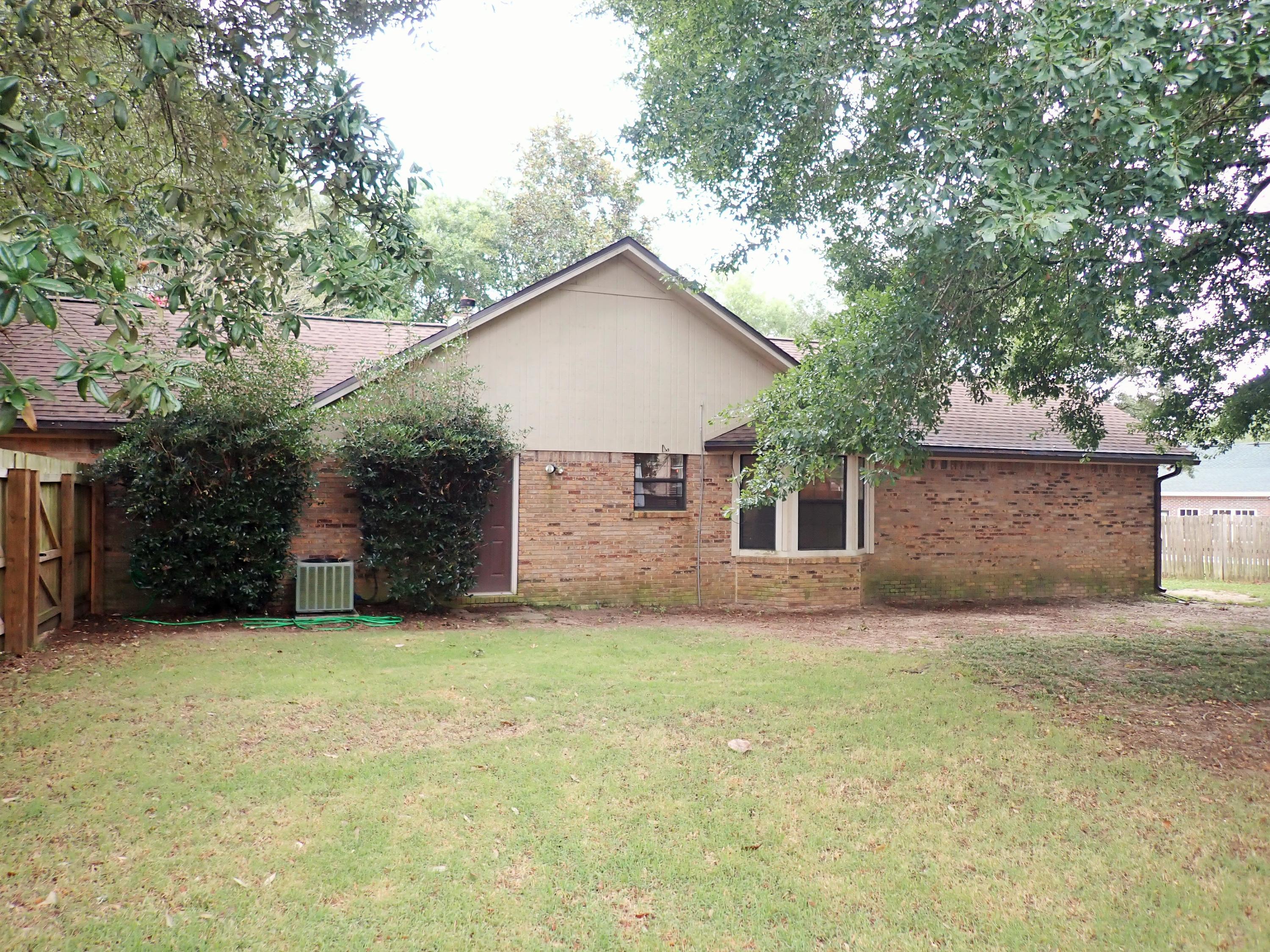 303 Sheldon Court Crestview, FL 32539 - Photo 41 of 45 a view of a house with a yard and large tree