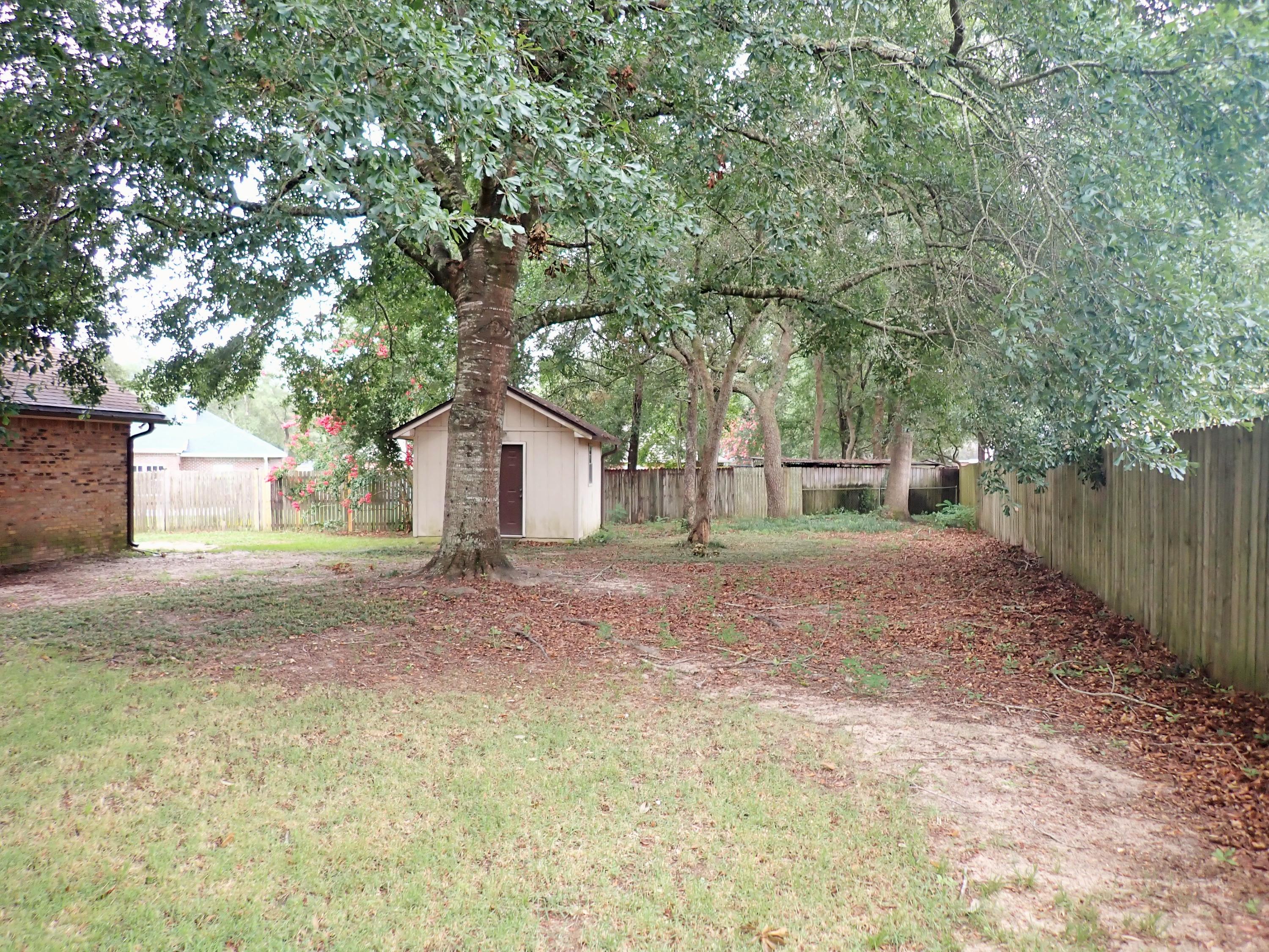 303 Sheldon Court Crestview, FL 32539 - Photo 42 of 45 a view of a house with a yard and tree