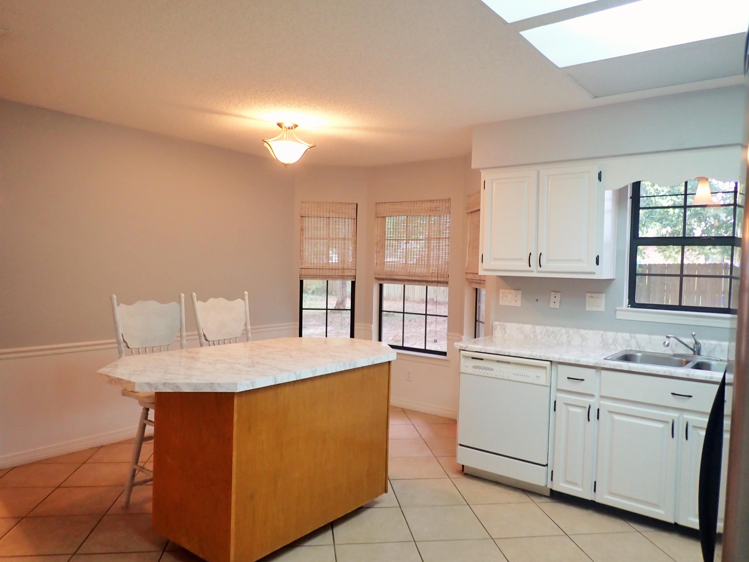 303 Sheldon Court Crestview, FL 32539 - Photo 8 of 45 a kitchen that has a sink and a stove